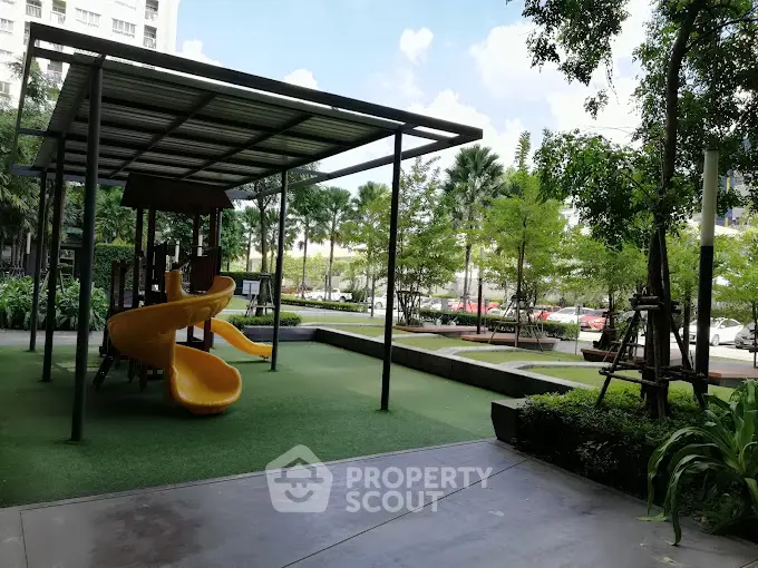 Modern apartment playground with slide and lush greenery