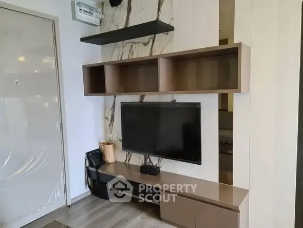 Modern living room with sleek TV unit and marble accent wall