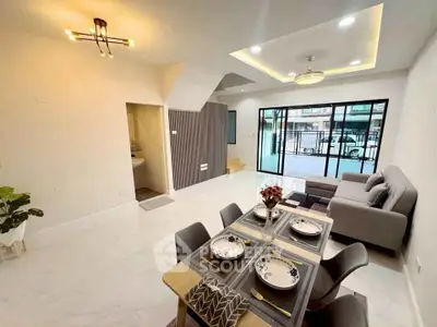 Modern open-plan living and dining area with stylish decor and ample natural light.