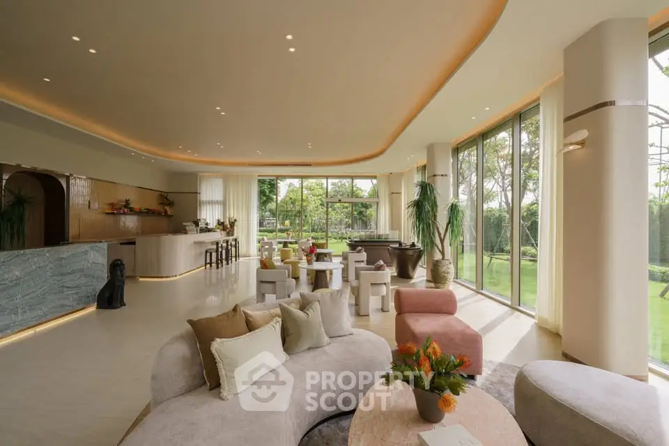 Luxurious open-layout living room with elegant decor and garden view, perfect for entertaining.