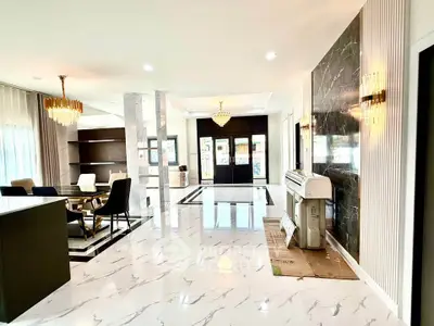 Luxurious open-plan living room with marble floors and elegant chandeliers