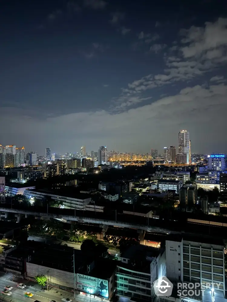 Stunning cityscape view from high-rise building at night with illuminated skyline.