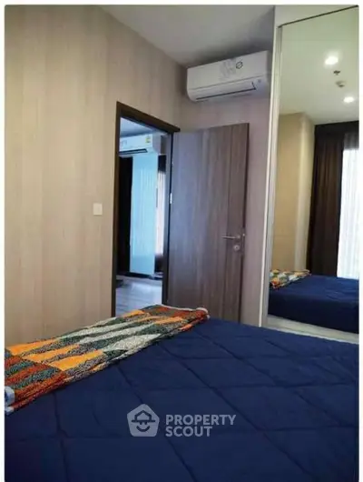 Modern bedroom with air conditioning and stylish decor in a cozy apartment.
