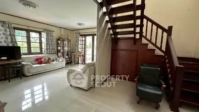 Charming living room with elegant staircase and cozy seating area