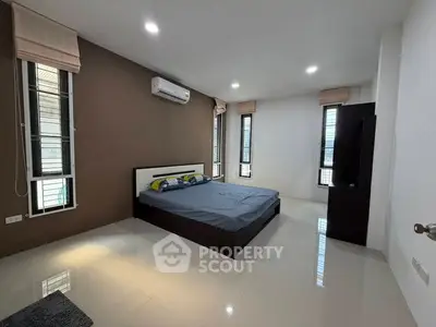 Spacious modern bedroom with sleek design and ample natural light