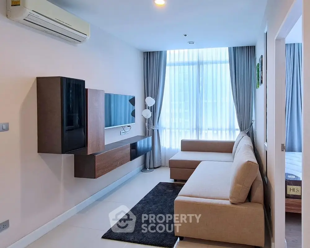 Modern living room with stylish furniture and large window in a contemporary apartment.