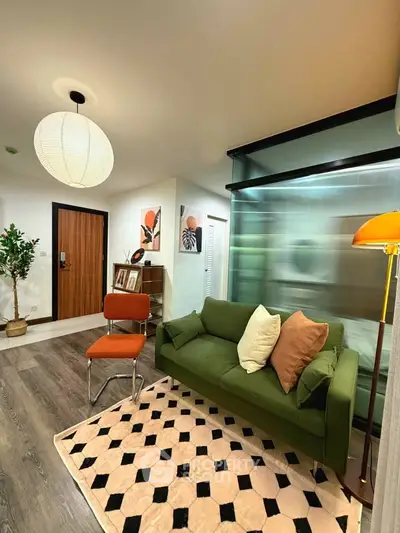 Stylish living room with green sofa, modern decor, and warm lighting