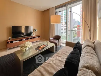 Modern living room with large windows and city view, featuring stylish furniture and elegant decor.