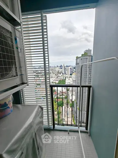 High-rise balcony with city view and laundry area, perfect for urban living.