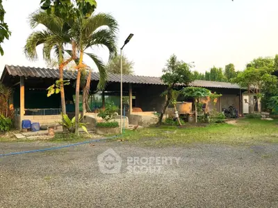 Charming rustic property with lush greenery and spacious outdoor area, perfect for serene living.