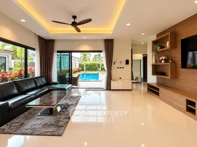 Luxurious living room with pool view, modern furniture, and elegant decor in a contemporary home.