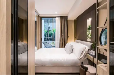 Modern bedroom with elegant decor and garden view, featuring a cozy bed and stylish furnishings.