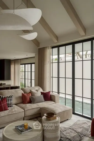 Luxurious living room with modern design, large windows, and stylish decor.