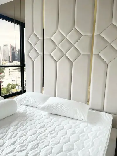 Luxurious bedroom with modern padded wall and city view
