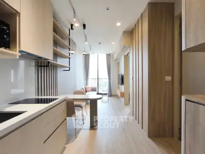 Modern open-layout kitchen and living room with sleek design and natural light