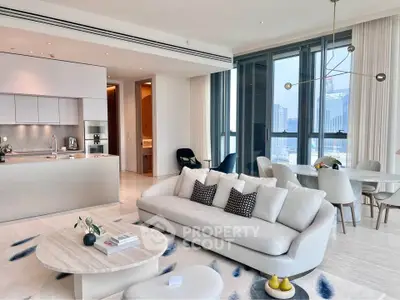 Luxurious open-plan living room with modern kitchen and stunning city views, perfect for urban living.