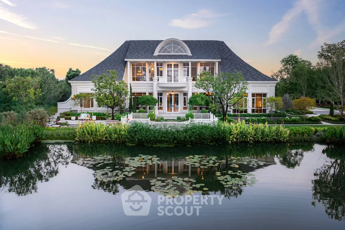 Stunning luxury mansion with elegant architecture and serene waterfront view.