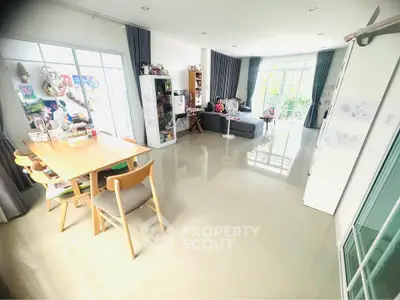 Spacious living room with modern decor and large windows for natural light.