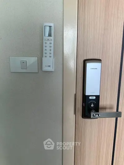 Modern apartment entrance with digital lock and remote control panel