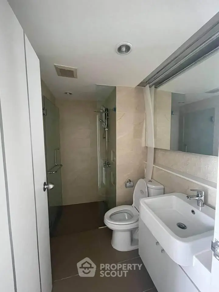 Modern bathroom with sleek fixtures and glass shower enclosure