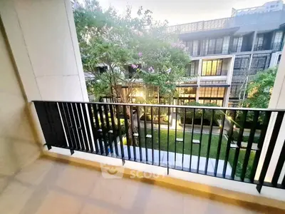 Spacious balcony with garden view in modern apartment complex