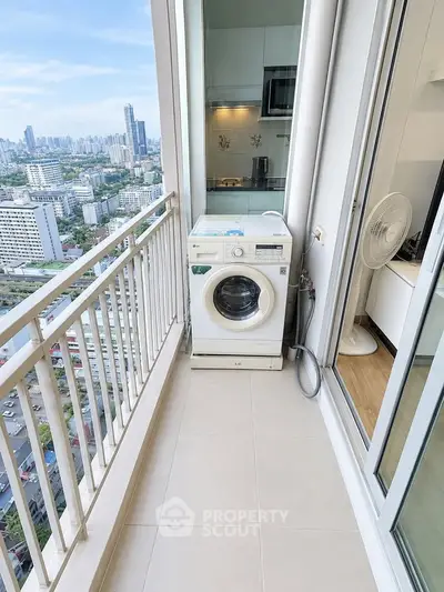 High-rise apartment balcony with washing machine and stunning city view