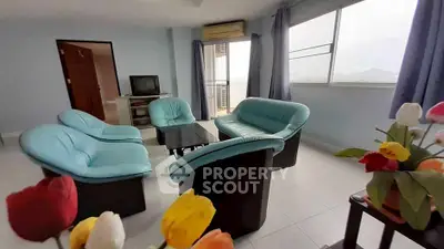 Spacious living room with blue sofas and mountain view, perfect for relaxation.