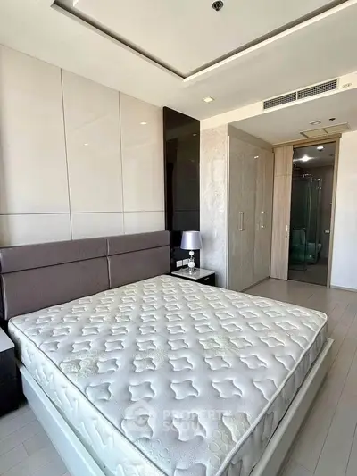 Modern bedroom with stylish decor and spacious layout in luxury apartment.