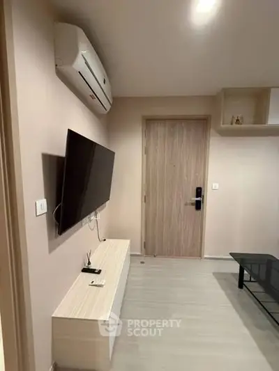 Modern living room with wall-mounted TV and air conditioning unit