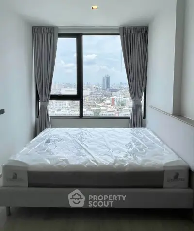 Modern bedroom with large window offering stunning city view, featuring a comfortable bed and elegant curtains.