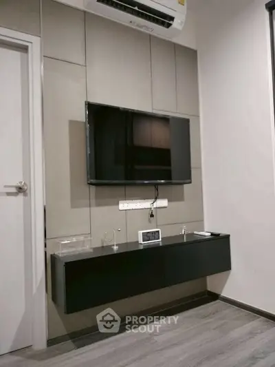 Modern living room with wall-mounted TV and sleek cabinetry