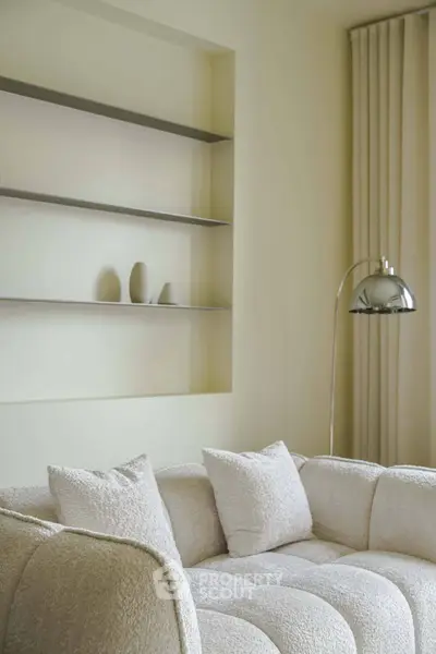 Elegant living room with plush white sofa and modern decor
