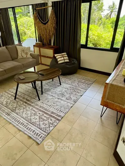 Charming living room with cozy seating and lush garden view.