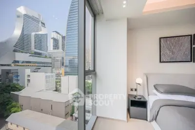 Modern bedroom with stunning city view from large window in high-rise apartment.