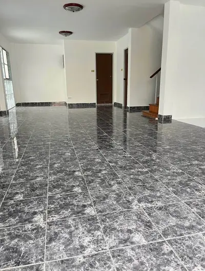 Spacious open-plan living area with elegant marble flooring and modern design.