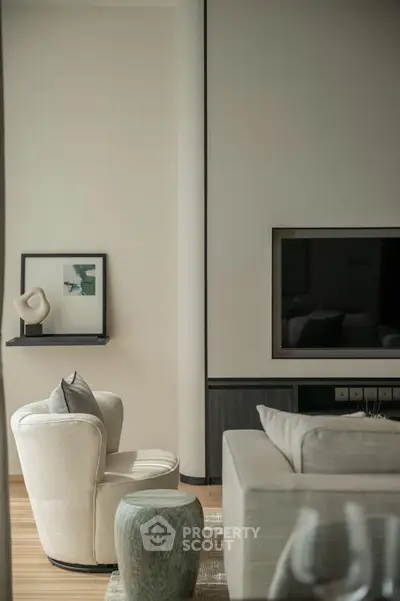 Elegant modern living room with stylish furniture and wall-mounted TV, perfect for relaxation and entertainment.