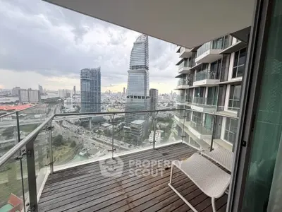 Stunning city view from modern high-rise balcony with glass railing and sleek design.