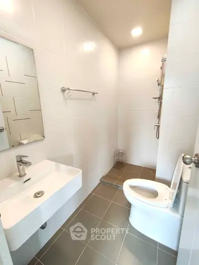 Modern bathroom with sleek white tiles and contemporary fixtures