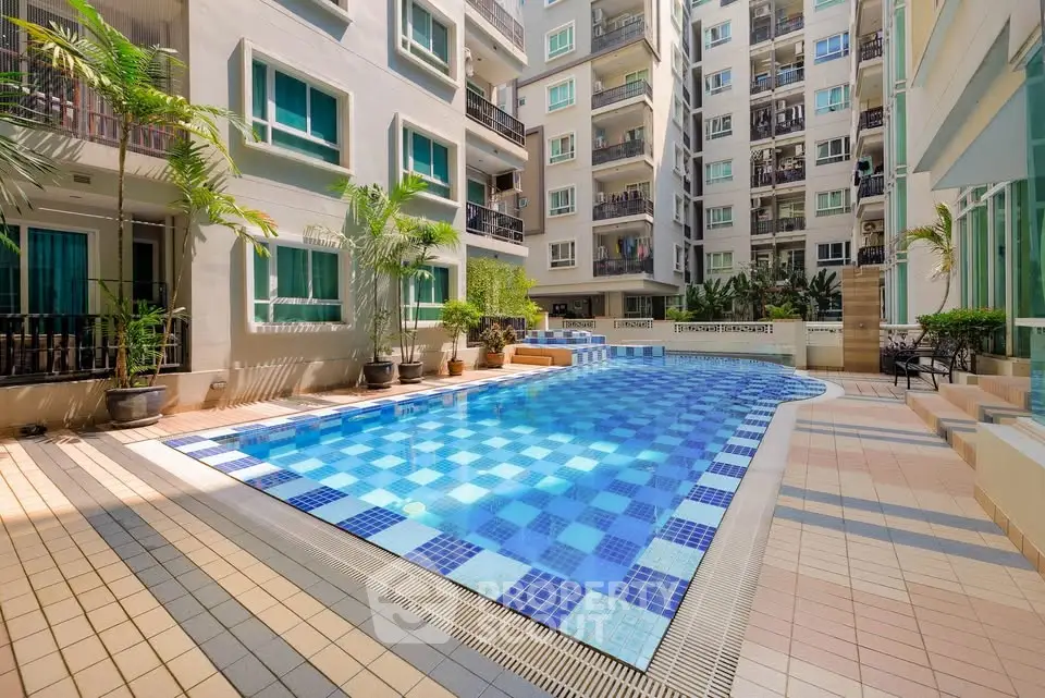 Luxurious condominium with a sparkling outdoor pool and modern architecture.