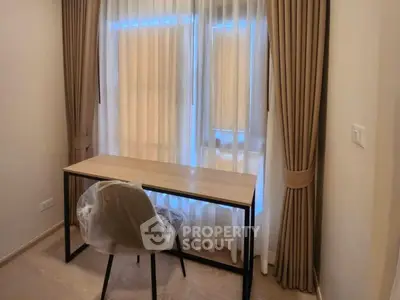 Cozy study room with modern desk and chair by window, ideal for productivity.