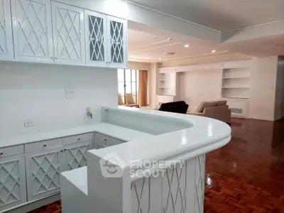 Spacious open-layout living room with elegant cabinetry and hardwood floors