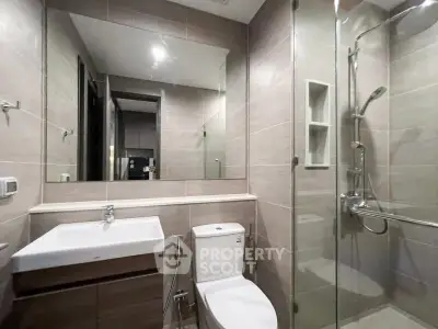 Modern bathroom with glass shower and sleek fixtures