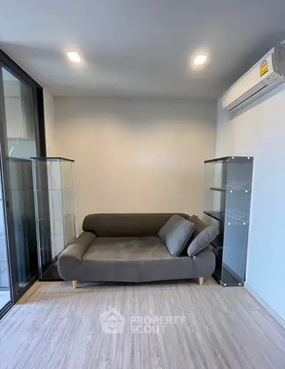 Modern living room with sleek sofa and glass display cabinets