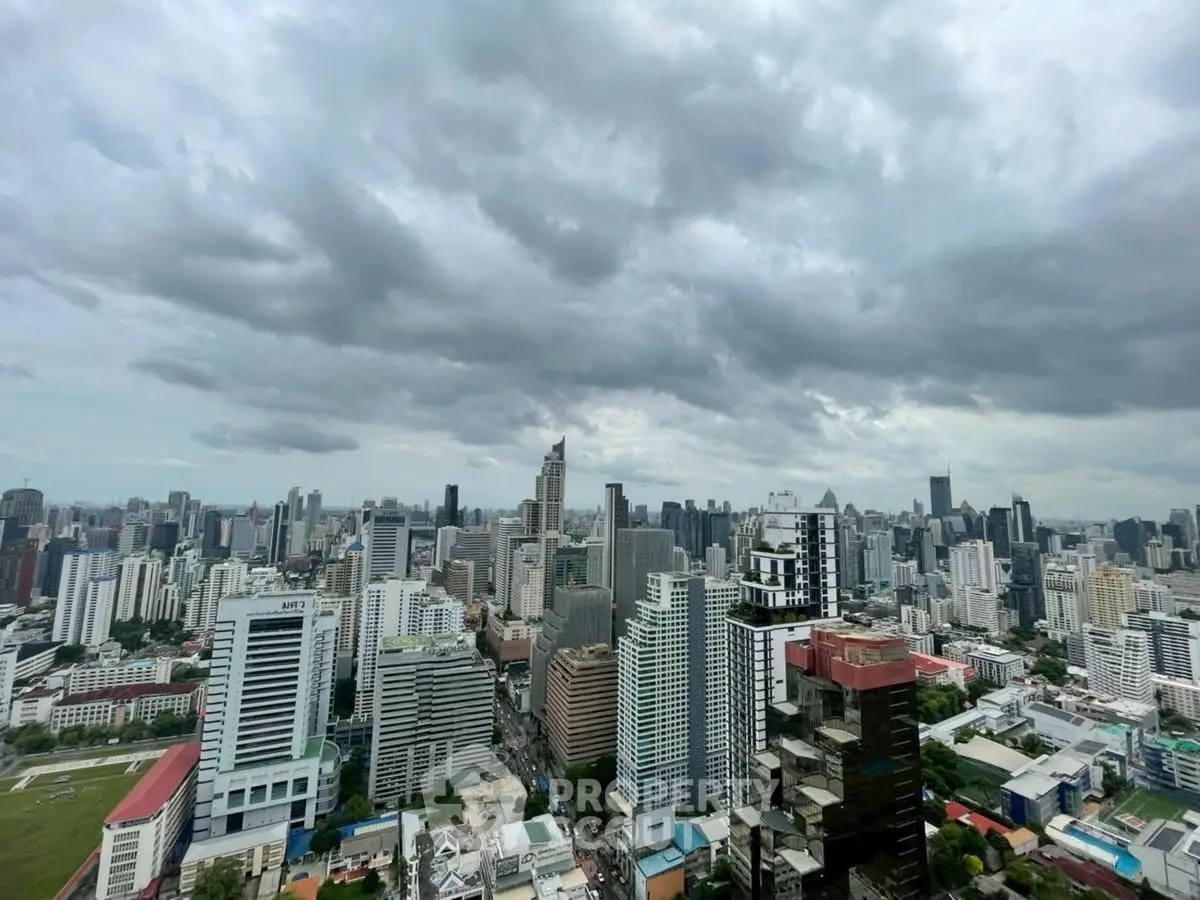 Stunning cityscape view showcasing a vibrant urban skyline under dramatic cloudy skies.