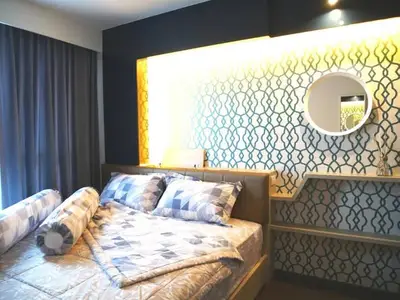 Stylish bedroom with modern geometric wallpaper and cozy bedding