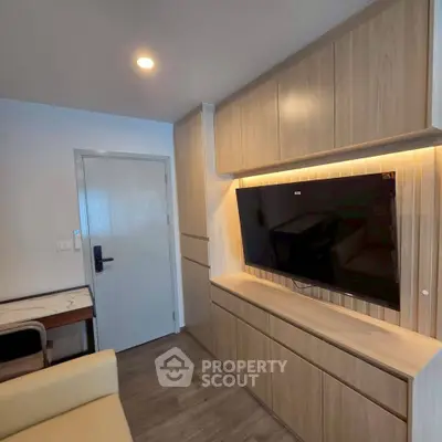Modern living room with built-in wooden cabinets and large TV
