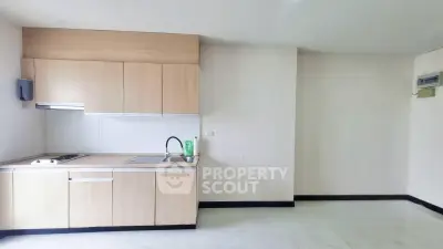 Modern minimalist kitchen with sleek cabinetry and open layout in a bright apartment.