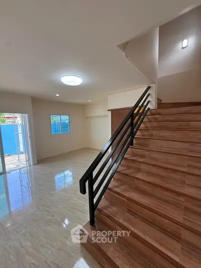 Spacious modern interior with elegant staircase and open layout, perfect for stylish living.