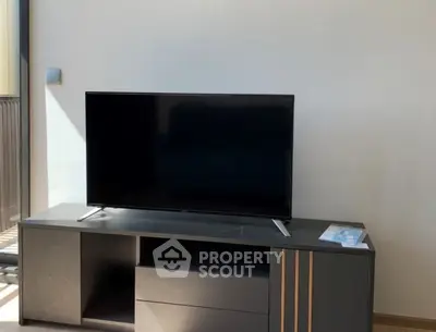 Modern living room with sleek TV stand and flat-screen television