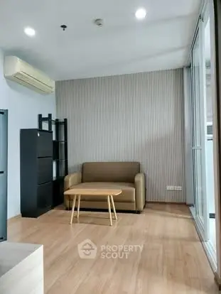 Modern living room with sofa, air conditioning, and wooden flooring